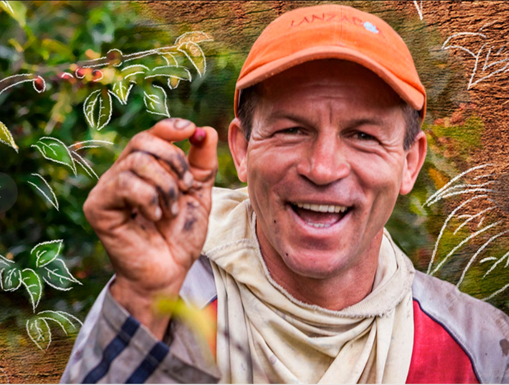 A smiling man with a coffee bean.